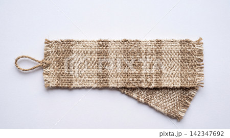 Handmade woven fabric bookmark with fringes placed on a white surface bookmark handmade literature accessory traditional material background creative creation decorator interior stationary Handmade woven fabric bookmark with fringes placed on a white surface bookmark handmade literature accessory traditional material background creative creation decorator interior stationary 142347692