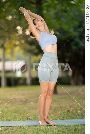 Adult woman doing yoga in park Adult woman doing yoga in park 142348488