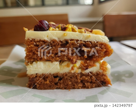 Slice of Carrot Cake with Cream Cheese Frosting and Mixed Nut Topping Slice of Carrot Cake with Cream Cheese Frosting and Mixed Nut Topping 142349797