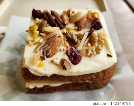 Nutty Carrot Cake with Cream Cheese Frosting and Mixed Toppings Nutty Carrot Cake with Cream Cheese Frosting and Mixed Toppings 142349798