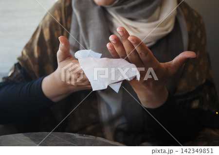 Woman cleaning her hands in a casual setting Woman cleaning her hands in a casual setting 142349851