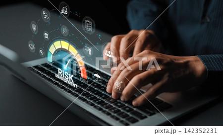 Close-up of hands typing on a laptop, showcasing a digital risk management concept with visual icons that represent financial analysis and decision-making tools in modern business. Sigmoid Close-up of hands typing on a laptop, showcasing a digital risk management concept with visual icons that represent financial analysis and decision-making tools in modern business. Sigmoid 142352231