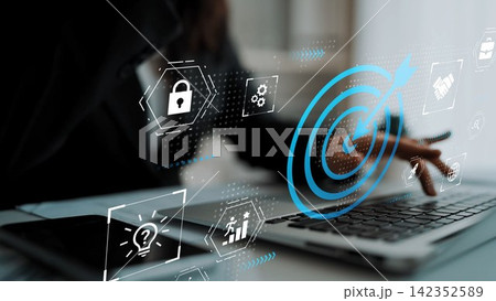 Close-up of a person using a laptop with digital icons representing security, innovation, and technology in a modern workspace setting Gluon Close-up of a person using a laptop with digital icons representing security, innovation, and technology in a modern workspace setting Gluon 142352589