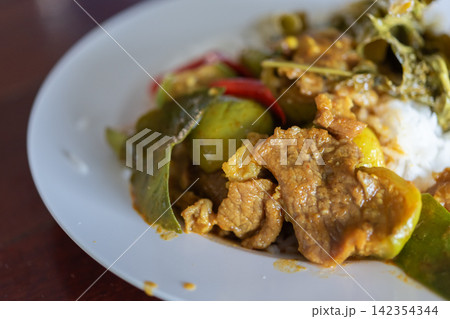 Traditional Thai pork curry served steamed rice eggplant kaffir lime leaves red chili rich spicy sauce showcasing authentic Asian cuisine 142354344