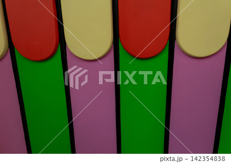 Colorful Wooden Fence Close Up Background with Red Yellow Green and Pink Panels 142354838