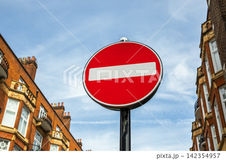 Red no entry road sign in an urban street 142354957