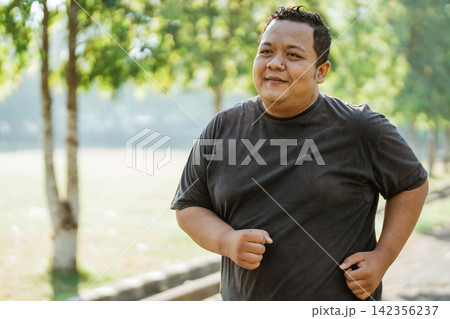 portrait of a fat man jogging in the morning in the park portrait of a fat man jogging in the morning in the park 142356237