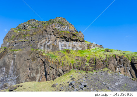 Rugged cliff landscape in Vestmannaeyjar, Iceland Rugged cliff landscape in Vestmannaeyjar, Iceland 142356916