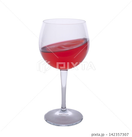 A clear glass wine goblet filled with red liquid A clear glass wine goblet filled with red liquid 142357307