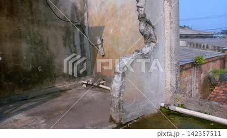 A partially demolished concrete wall in an abandoned building. A partially demolished concrete wall in an abandoned building. 142357511