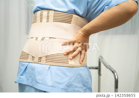 Asian senior pain back wearing elastic support belt with walker. Asian senior pain back wearing elastic support belt with walker. 142358655