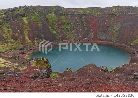 Kerid crater with a turquoise lake enclosed by red scoria walls, Iceland Kerid crater with a turquoise lake enclosed by red scoria walls, Iceland 142358830