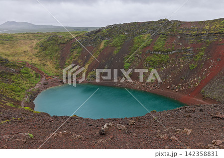 Kerid crater with the curved rim sweeping around the basin, Iceland, in diffuse afternoon light Kerid crater with the curved rim sweeping around the basin, Iceland, in diffuse afternoon light 142358831