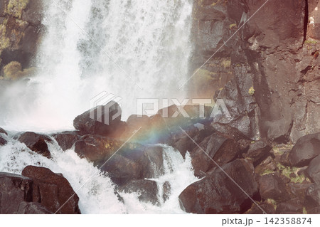 Oxararfoss waterfall and natural rainbow in warm-cyan vintage film color, Thingvellir, Iceland Oxararfoss waterfall and natural rainbow in warm-cyan vintage film color, Thingvellir, Iceland 142358874