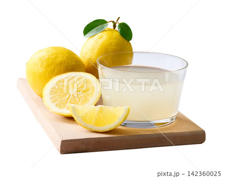 freshly squeezed lemon juice. Ripe lemons fruit and glass of lemon juice isolated on white background. 142360025
