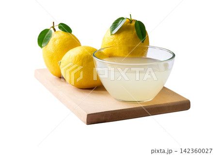 Ripe lemons fruit and bowl of lemon juice isolated on white background. freshly squeezed lemon juice . 142360027