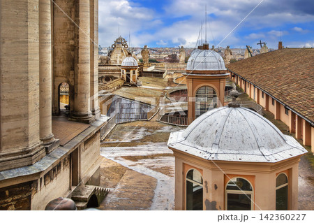 Roof of St. Peter's Basilica in Vatican, close view. Renaissance architecture with glass lanterns, light clouds Roof of St. Peter's Basilica in Vatican, close view. Renaissance architecture with glass lanterns, light clouds 142360227