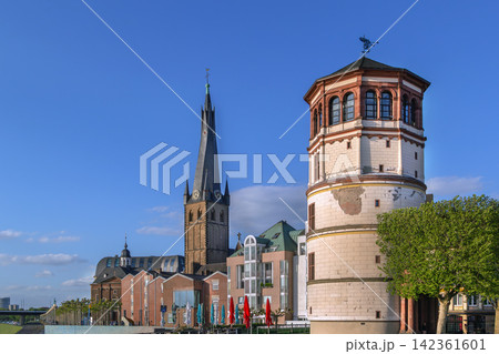 Old Castle Tower and St Lambertus church view from Rhine embankment in Dusseldorf Germany. Historic city architecture skyline 142361601