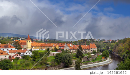 Minorite Monastery view across Vltava river in Cesky Krumlov, Czechia. Medieval religious architecture under cloudy sky Minorite Monastery view across Vltava river in Cesky Krumlov, Czechia. Medieval religious architecture under cloudy sky 142361632