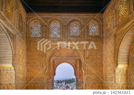 Hall interior with arched windows and carved walls in Generalife palace of Granada, Spain. Soft natural light in ancient room 142361821