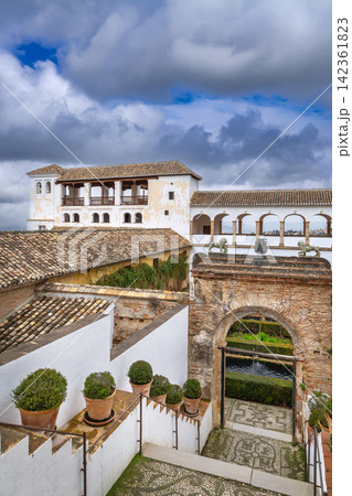 Stone stairs leading to Court of the Sultana in Generalife gardens of Granada, Spain. Architecture view under cloudy gray sky 142361823
