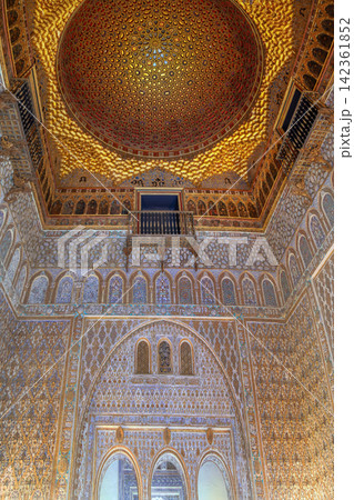 Ornate Mudejar ceiling and carved wall in Royal Alcazar of Seville Spain. Ancient Islamic geometric patterns in stone Ornate Mudejar ceiling and carved wall in Royal Alcazar of Seville Spain. Ancient Islamic geometric patterns in stone 142361852