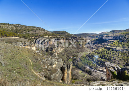 High angle view of Huecar River canyon near Cuenca, Spain. Deep rocky gorge and natural landscape under sunny sky, no people High angle view of Huecar River canyon near Cuenca, Spain. Deep rocky gorge and natural landscape under sunny sky, no people 142361914