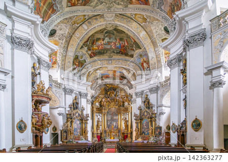 Interior of the church at Banz Abbey, Germany. View of the baroque nave with ornate columns. Bright indoor lighting Interior of the church at Banz Abbey, Germany. View of the baroque nave with ornate columns. Bright indoor lighting 142363277