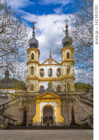 Scenic view of Kappele Pilgrimage Church and stairs in Wurzburg Germany. Baroque Wallfahrtskirche facade under partly cloudy sky Scenic view of Kappele Pilgrimage Church and stairs in Wurzburg Germany. Baroque Wallfahrtskirche facade under partly cloudy sky 142363291