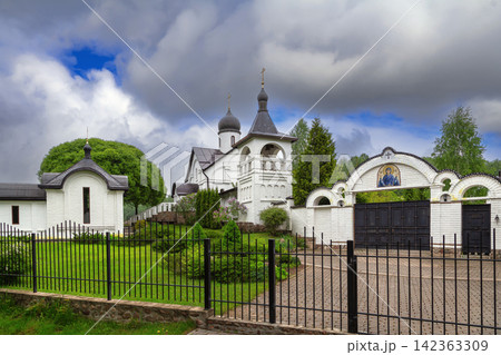 St. Vvedensky Convent complex in Bogushi, Belarus panoramic view. Partly cloudy sky over Novgorod style orthodox monastery St. Vvedensky Convent complex in Bogushi, Belarus panoramic view. Partly cloudy sky over Novgorod style orthodox monastery 142363309