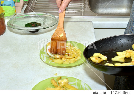 The hostess arranges food on plates. The hostess arranges food on plates. 142363663