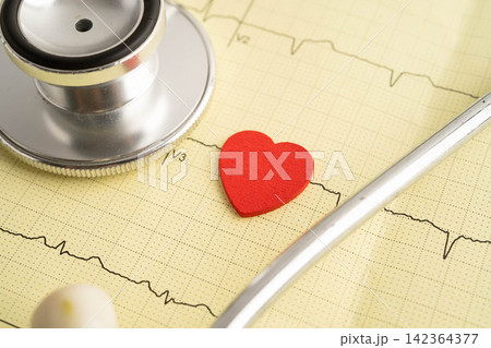 Stethoscope on electrocardiogram ECG, heart wave, heart attack, cardiogram report. Stethoscope on electrocardiogram ECG, heart wave, heart attack, cardiogram report. 142364377