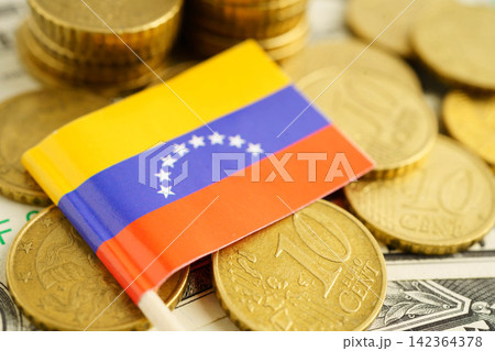 Venezuela flag on coin and banknote money, finance trading investment business currency concept. Venezuela flag on coin and banknote money, finance trading investment business currency concept. 142364378