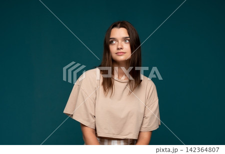 Young woman thinking, looking away, reflecting on thoughts with a serious expression and copy space 142364807