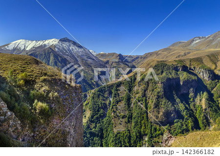 Caucasus mountain peaks near Gudauri in Georgia, majestic alpine highland landscape. Sunny day with bright blue sky Caucasus mountain peaks near Gudauri in Georgia, majestic alpine highland landscape. Sunny day with bright blue sky 142366182