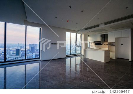 empty space of the kitchen of a condominium room with the view of the big city outside empty space of the kitchen of a condominium room with the view of the big city outside 142366447