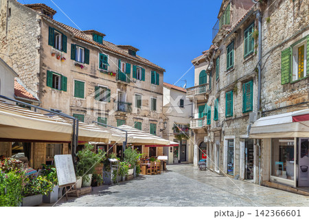 Street in historical center of Split Croatia view. Ancient stone buildings under sunny sky Street in historical center of Split Croatia view. Ancient stone buildings under sunny sky 142366601