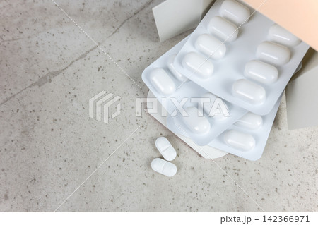 White pills and cardboard on the nature stone background. Healthcare concept. Space for text. 142366971