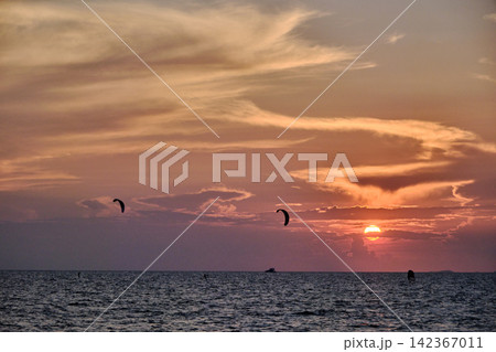 red twilight sky of sunset scene with cloudy sky over the open ocean with many waves red twilight sky of sunset scene with cloudy sky over the open ocean with many waves 142367011
