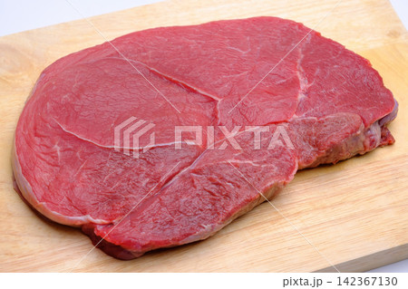 raw fresh beef knuckle steak cut on wood cutting board isolated on white background raw fresh beef knuckle steak cut on wood cutting board isolated on white background 142367130
