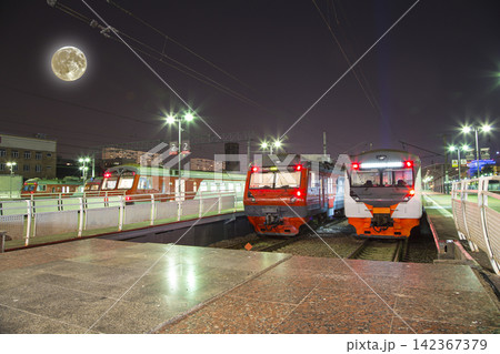 Train on Moscow passenger platform (Savelovsky railway station) with the super moon -- is one of the nine main railway stations in Moscow, Russia (at night) Train on Moscow passenger platform (Savelovsky railway station) with the super moon -- is one of the nine main railway stations in Moscow, Russia (at night) 142367379