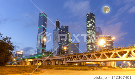 Moscow Central Circle (Little Ring, MCC, or MK MZD) and skyscrapers of the International Business Center (City) at night, with the super moon, Russia. Delovoy Tsentr railway station Moscow Central Circle (Little Ring, MCC, or MK MZD) and skyscrapers of the International Business Center (City) at night, with the super moon, Russia. Delovoy Tsentr railway station 142367401