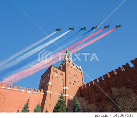 Moscow Kremlin, Russia -- Victory Day celebration (WWII), and Russian military aircraft with painted russian flag, Russia Moscow Kremlin, Russia -- Victory Day celebration (WWII), and Russian military aircraft with painted russian flag, Russia 142367535