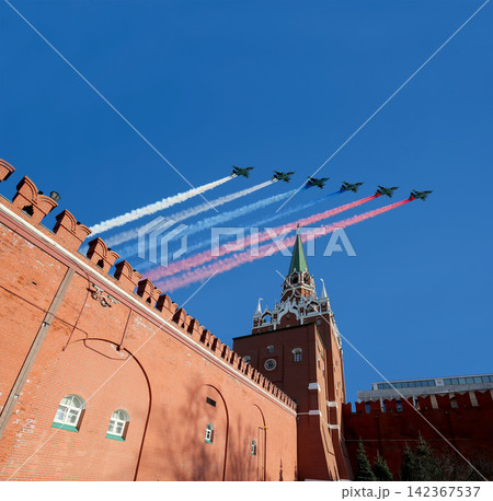 Moscow Kremlin, Russia -- Victory Day celebration (WWII), and Russian military aircraft with painted russian flag, Russia Moscow Kremlin, Russia -- Victory Day celebration (WWII), and Russian military aircraft with painted russian flag, Russia 142367537