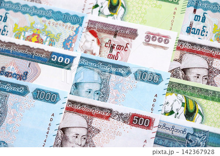 Myanmar kyat paper banknotes pile on table. Myanmar MMK currency money bills in big amount Myanmar kyat paper banknotes pile on table. Myanmar MMK currency money bills in big amount 142367928