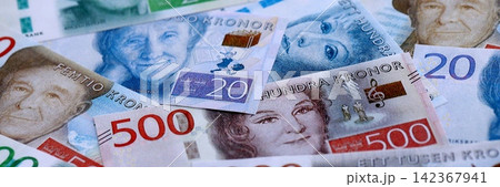 Swedish krona paper banknotes pile on table. Sweden SEK currency money bills in big amount Swedish krona paper banknotes pile on table. Sweden SEK currency money bills in big amount 142367941