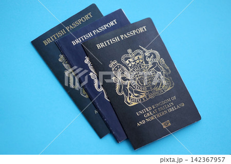 British and Gibraltar passports on table. Official identification document books for citizens of UK British and Gibraltar passports on table. Official identification document books for citizens of UK 142367957