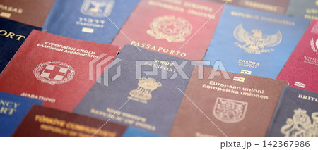 Big amount of passports of various different countries. Covers of expired passports close up Big amount of passports of various different countries. Covers of expired passports close up 142367986