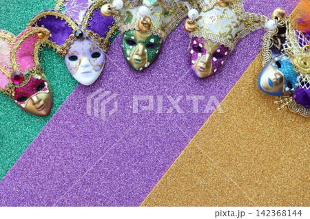 Mardi gras background with mask and feather. Conceptual colorful image Mardi gras background with mask and feather. Conceptual colorful image 142368144