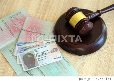 German temporary Permanent resident card lies with judge hammer. Aufenthaltstitel German temporary Permanent resident card lies with judge hammer. Aufenthaltstitel 142368174